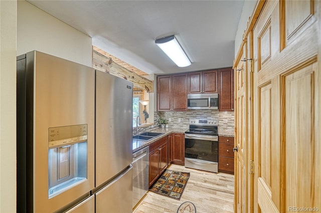 18766 State Highway 67, Divide, CO 80814 - kitchen featuring stainless steel appliances, a sink, light wood-style floors, decorative backsplash, and light stone countertops