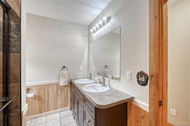 18766 State Highway 67, Divide, CO 80814 - bathroom featuring double vanity, wainscoting, wood walls, and tile patterned floors