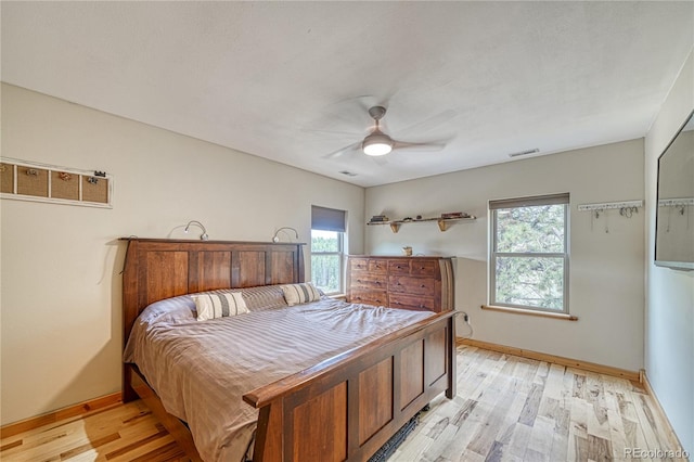 18766 State Highway 67, Divide, CO 80814 - bedroom featuring multiple windows, light wood-type flooring, baseboards, and a ceiling fan