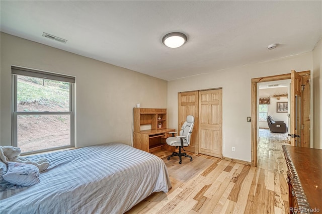 18766 State Highway 67, Divide, CO 80814 - bedroom with light wood-style flooring, a desk, a closet, and baseboards
