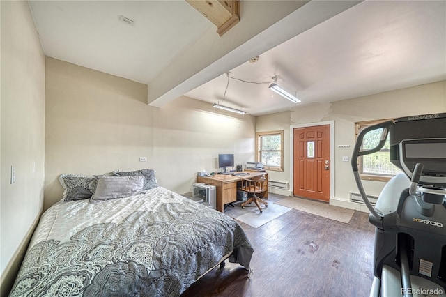 18766 State Highway 67, Divide, CO 80814 - bedroom with wood finished floors, baseboard heating, baseboards, a baseboard heating unit, and an office area