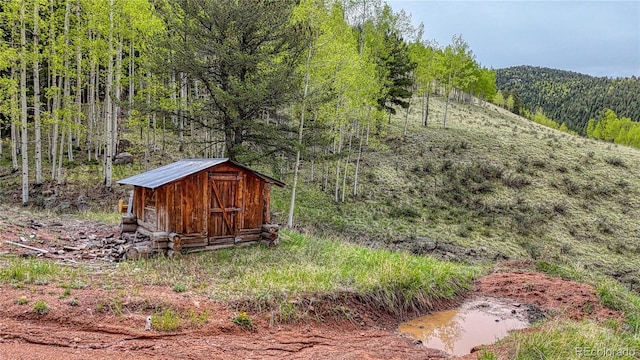 18766 State Highway 67, Divide, CO 80814 - view of shed featuring a view of trees