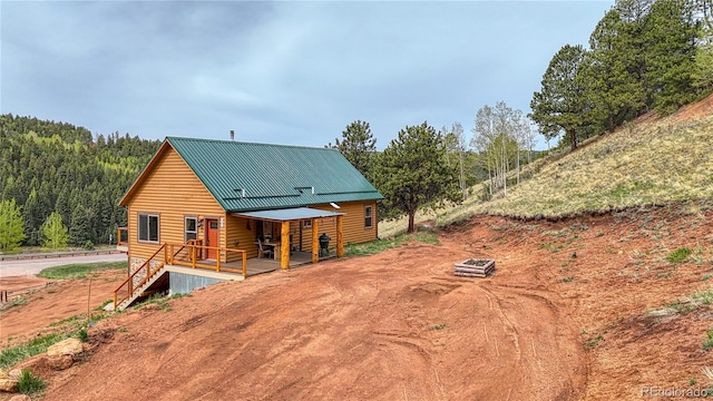 18766 State Highway 67, Divide, CO 80814 - back of property with a wooded view and metal roof