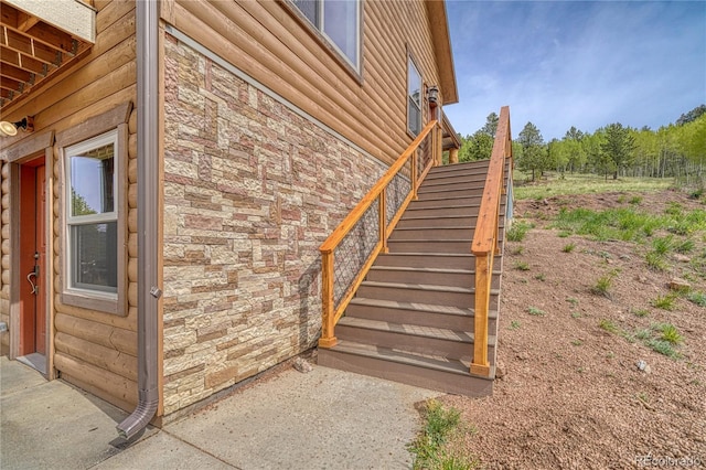 18766 State Highway 67, Divide, CO 80814 - view of side of home featuring stairway, stone siding, and faux log siding