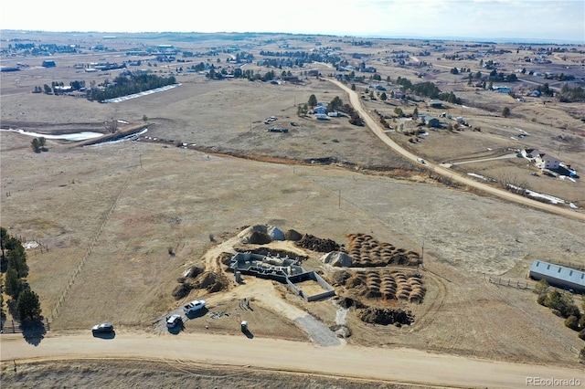 birds eye view of property with a rural view