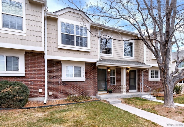18397 E Alabama Pl Unit D, Aurora, CO 80017 - view of property featuring brick siding and a front lawn