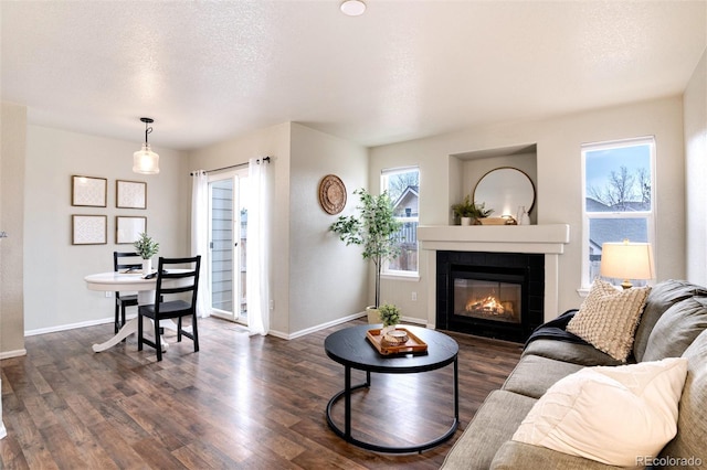 18397 E Alabama Pl Unit D, Aurora, CO 80017 - living area with dark wood-type flooring, a fireplace, baseboards, and a textured ceiling