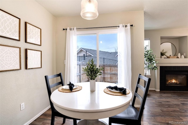 18397 E Alabama Pl Unit D, Aurora, CO 80017 - dining room featuring dark wood finished floors, baseboards, and a tiled fireplace