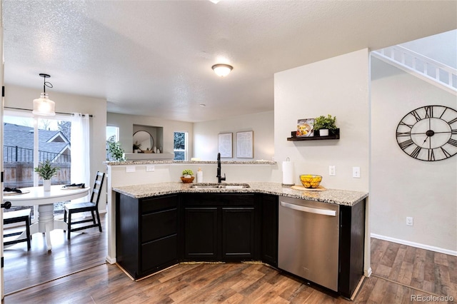 18397 E Alabama Pl Unit D, Aurora, CO 80017 - kitchen featuring stainless steel dishwasher, a sink, dark cabinets, a peninsula, and dark wood-style floors