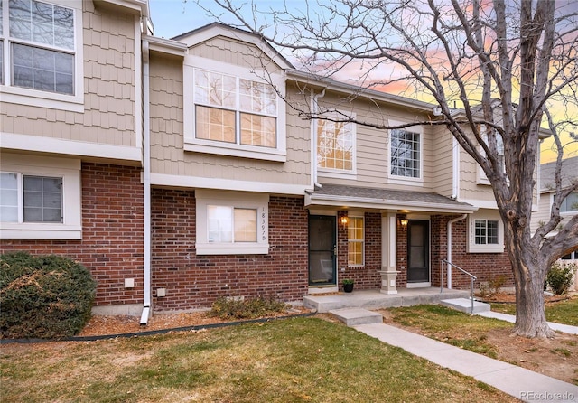18397 E Alabama Pl Unit D, Aurora, CO 80017 - view of property featuring a lawn and brick siding