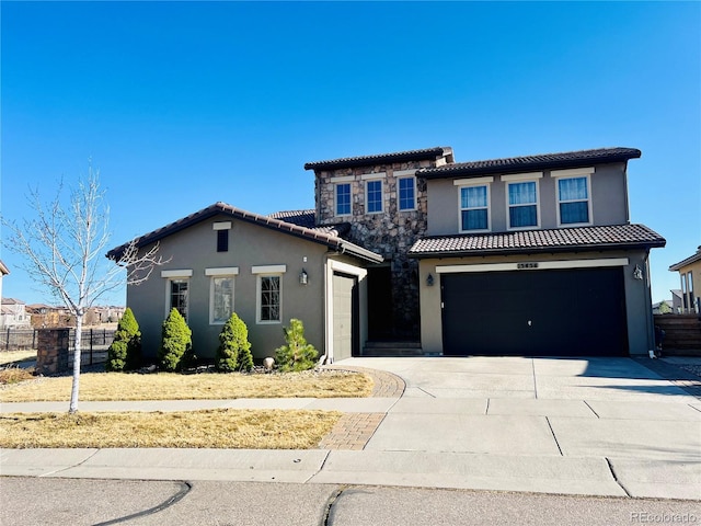 view of front of property with driveway, stucco siding, a garage, stone siding, and a tile roof