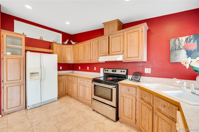 7725 Hummingbird Grn Unit 78, Frederick, CO 80530 - kitchen featuring white refrigerator with ice dispenser, stainless steel electric range oven, under cabinet range hood, light countertops, and a sink