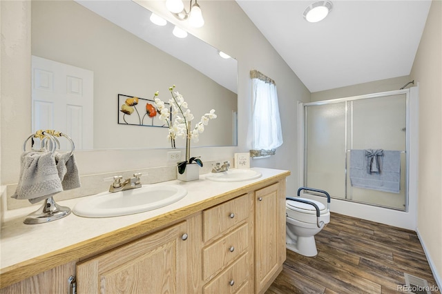 7725 Hummingbird Grn Unit 78, Frederick, CO 80530 - bathroom featuring a stall shower, toilet, double vanity, wood finished floors, and lofted ceiling