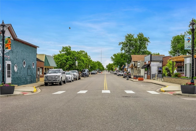 7725 Hummingbird Grn Unit 78, Frederick, CO 80530 - view of asphalt road with street lights, sidewalks, curbs, and a residential view