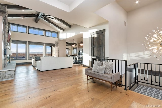 3947 Taliesin Way, Fort Collins, CO 80524 - living room featuring visible vents, high vaulted ceiling, beam ceiling, wood-type flooring, and ceiling fan with notable chandelier