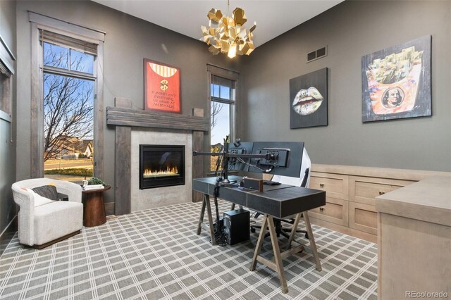 3947 Taliesin Way, Fort Collins, CO 80524 - home office featuring a notable chandelier, visible vents, a healthy amount of sunlight, and a glass covered fireplace