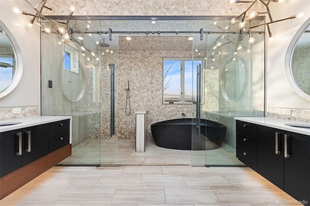 3947 Taliesin Way, Fort Collins, CO 80524 - full bathroom with an inviting chandelier, a soaking tub, two vanities, a stall shower, and a sink