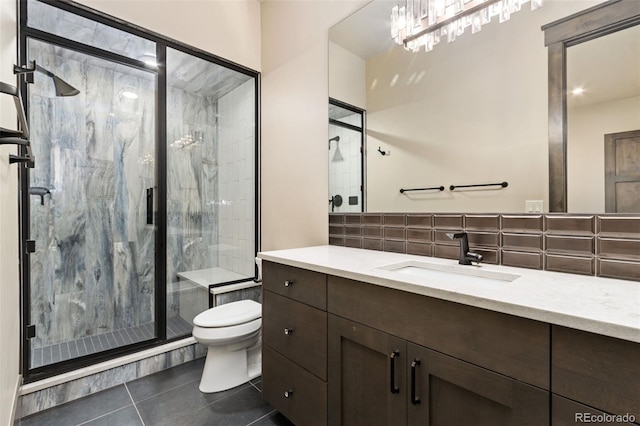 3947 Taliesin Way, Fort Collins, CO 80524 - full bathroom featuring vanity, a marble finish shower, decorative backsplash, tile patterned floors, and toilet