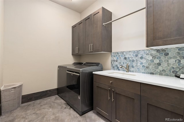 3947 Taliesin Way, Fort Collins, CO 80524 - clothes washing area with cabinet space, separate washer and dryer, baseboards, and a sink