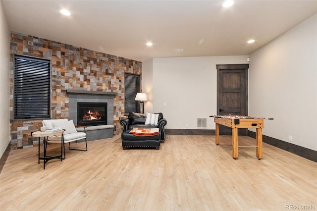 3947 Taliesin Way, Fort Collins, CO 80524 - living room with visible vents, wood finished floors, recessed lighting, a stone fireplace, and baseboards