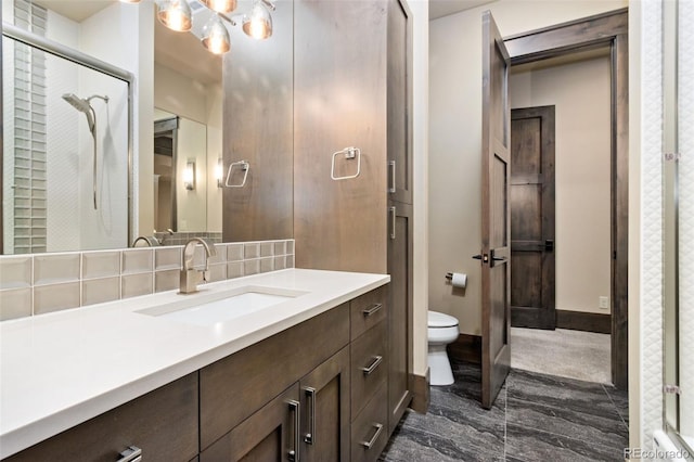 3947 Taliesin Way, Fort Collins, CO 80524 - full bathroom featuring backsplash, baseboards, toilet, a notable chandelier, and vanity