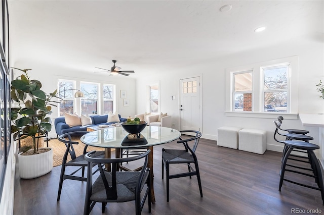 dining area with ceiling fan, plenty of natural light, and dark wood-type flooring