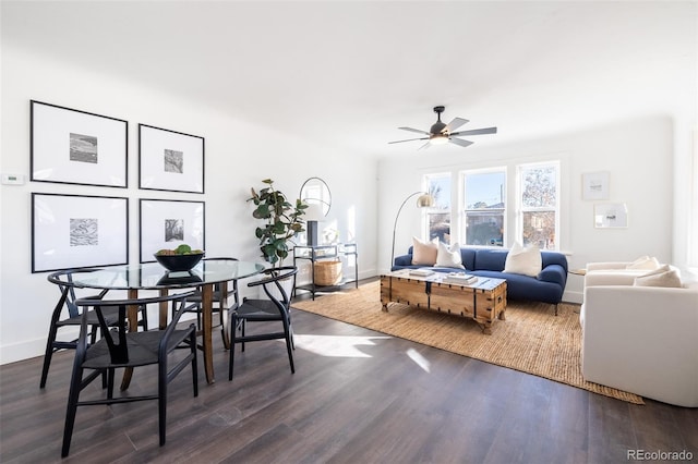 living room with ceiling fan and dark wood-type flooring