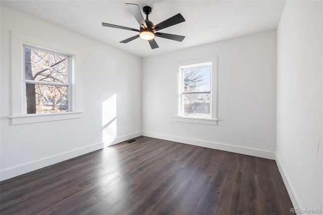 unfurnished room featuring ceiling fan, dark hardwood / wood-style floors, and a healthy amount of sunlight