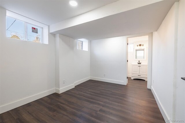 basement with sink and dark hardwood / wood-style flooring