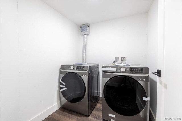 laundry room with dark hardwood / wood-style floors and washing machine and dryer