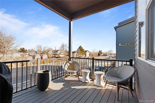 wooden terrace featuring a residential view