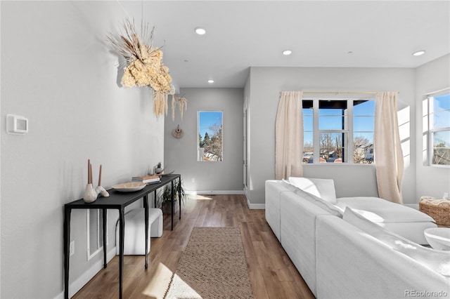 interior space featuring recessed lighting, baseboards, and wood finished floors