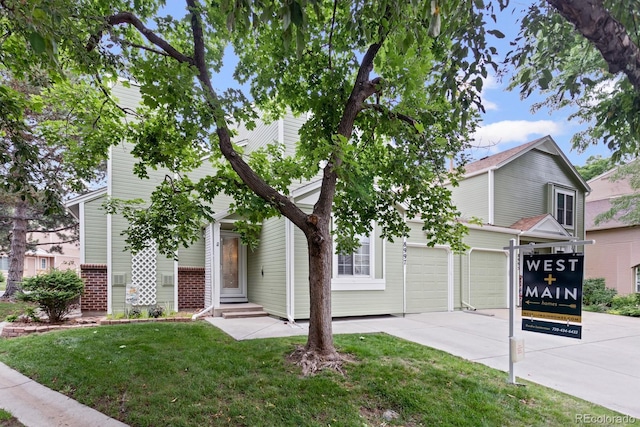 8997 W 88th Ave, Westminster, CO 80021 - obstructed view of property featuring driveway, a front lawn, and entry steps