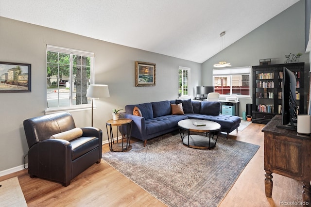 8997 W 88th Ave, Westminster, CO 80021 - living room with light wood-style floors, plenty of natural light, and high vaulted ceiling