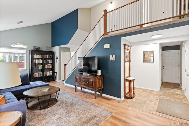 8997 W 88th Ave, Westminster, CO 80021 - living area with high vaulted ceiling, stairs, and wood finished floors