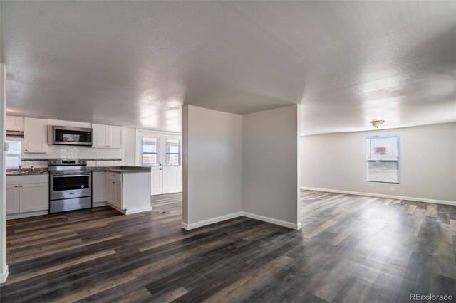 530 Illinois St, Penrose, CO 81240 - kitchen with a textured ceiling, stainless steel appliances, dark hardwood / wood-style floors, and white cabinets