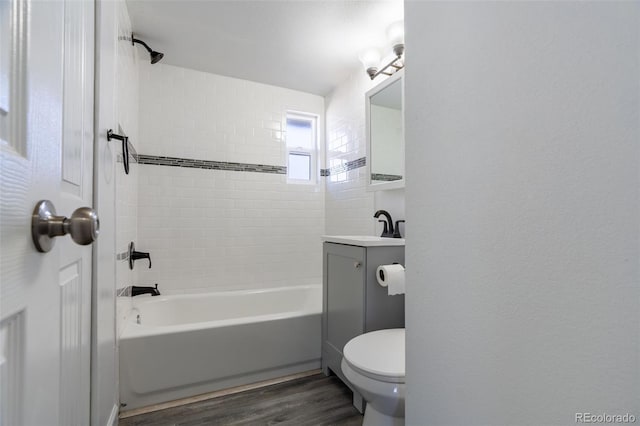530 Illinois St, Penrose, CO 81240 - full bathroom featuring vanity, hardwood / wood-style flooring, tiled shower / bath combo, and toilet