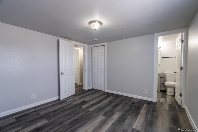 530 Illinois St, Penrose, CO 81240 - unfurnished bedroom with a closet, dark hardwood / wood-style floors, and ensuite bathroom
