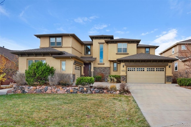 1053 Crystal Basin Dr, Colorado Springs, CO 80921 - prairie-style house with stucco siding, stone siding, concrete driveway, and a garage