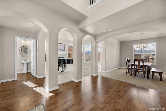 dining area featuring dark hardwood / wood-style floors and an inviting chandelier