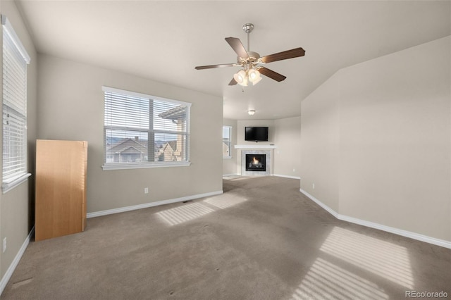 1053 Crystal Basin Dr, Colorado Springs, CO 80921 - unfurnished living room featuring a ceiling fan, carpet flooring, a fireplace, and vaulted ceiling