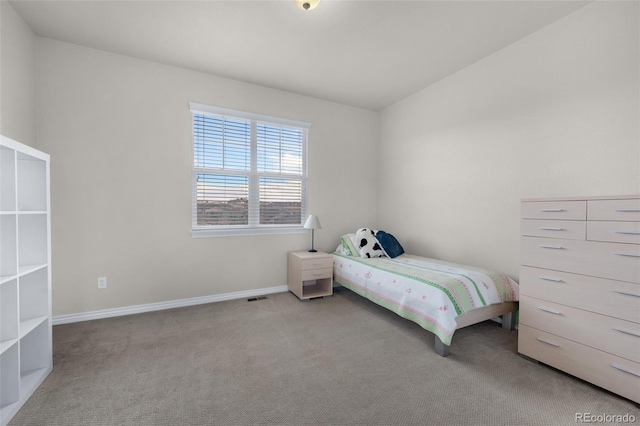 carpeted bedroom with vaulted ceiling