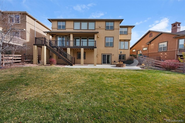 rear view of house featuring a yard and a patio