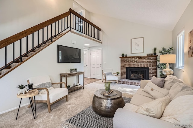 8993 W 88th Pl, Westminster, CO 80021 - carpeted living room featuring stairway, a fireplace, and high vaulted ceiling