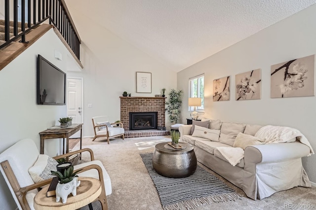 8993 W 88th Pl, Westminster, CO 80021 - carpeted living room with a fireplace, a textured ceiling, and high vaulted ceiling