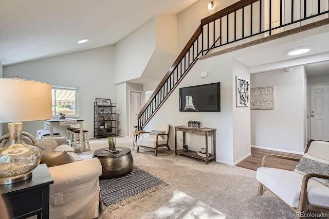 8993 W 88th Pl, Westminster, CO 80021 - living room featuring high vaulted ceiling, stairs, and carpet flooring
