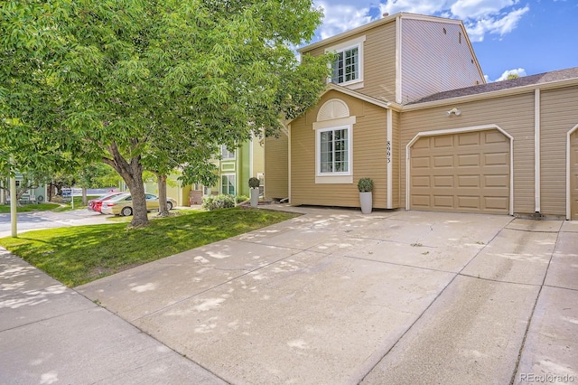 8993 W 88th Pl, Westminster, CO 80021 - view of front of house with concrete driveway, an attached garage, and a front lawn