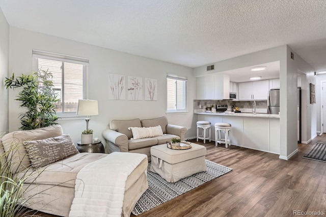 8993 W 88th Pl, Westminster, CO 80021 - living room with dark wood-style floors and a textured ceiling