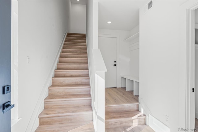 stairway featuring wood-type flooring