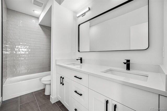 full bathroom with tile patterned flooring, vanity, toilet, and tiled shower / bath combo